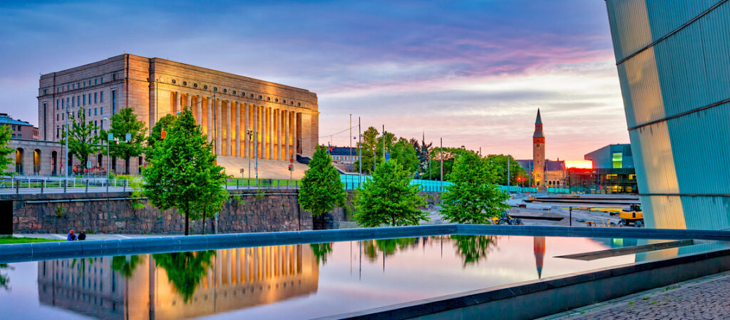 Parliament House and its reflection in Helsinki Finland at sunset.