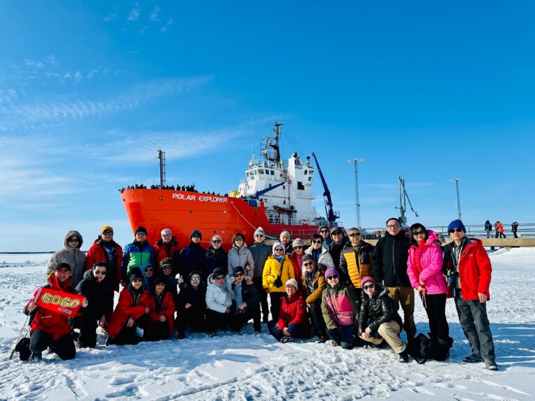 GoGo Tours travelers posing in front of the Polar Explorer icebreaker ship on the Arctic Circle 9-Day Tour.