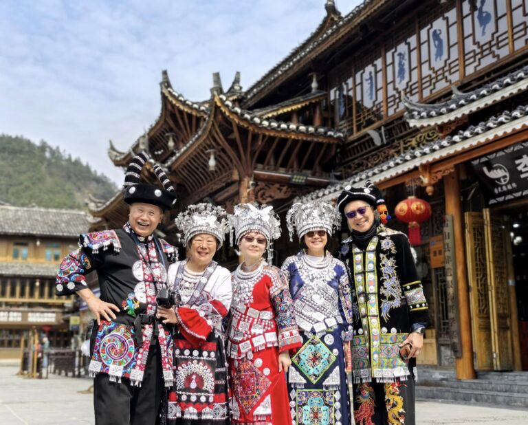 Tourists dressed in vibrant traditional Miao attire