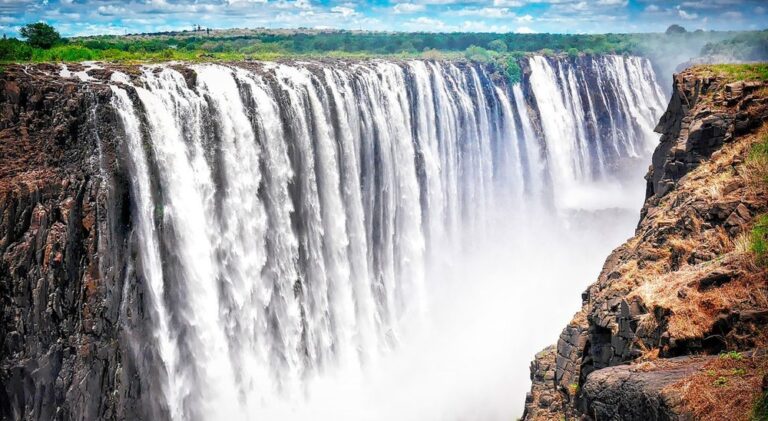 Breathtaking view of Victoria Falls in Zimbabwe, one of the Seven Natural Wonders of the World, featured in GoGo Tours’ East Africa 15-day tour.