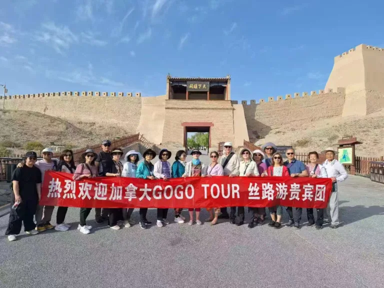 GoGo Tours travelers group photo at Jiayuguan Great Wall, Gansu, China