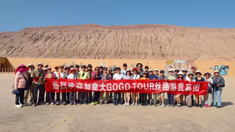 GoGo Tours travelers holding a Silk Road tour banner