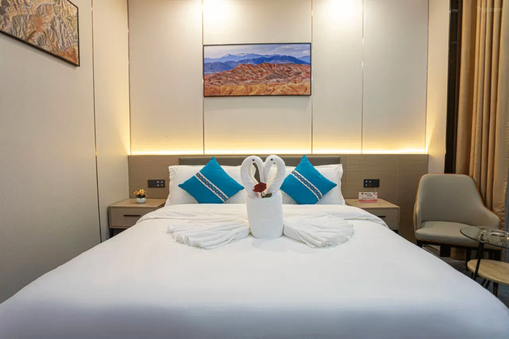Elegant hotel room at Jin Ling Xuan Hotel with towel art.