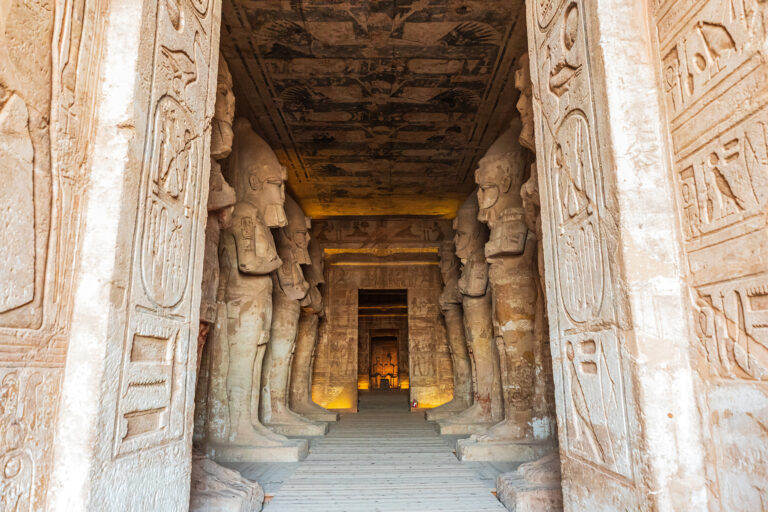 Interior of Abu Simbel Temple with ancient statues and hieroglyphs.