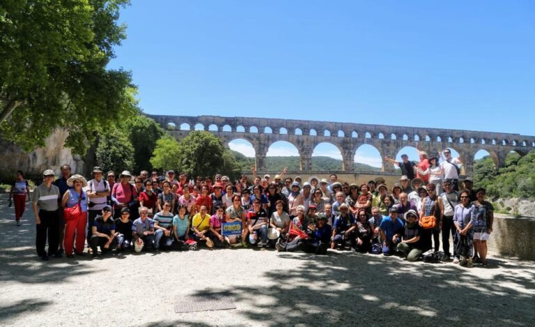 GoGo Tours travelers posing at the Pont du Gard Roman aqueduct in southern France
