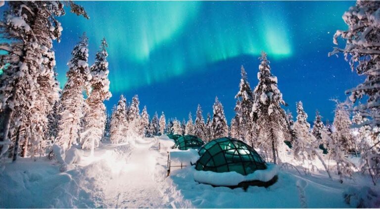 Glass igloos illuminated under the Northern Lights during GoGo Tours’ Arctic Circle 9-Day Tour.
