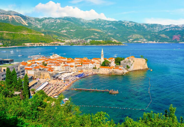 Aerial view of Budva Old Town with the Adriatic Sea and mountains.
