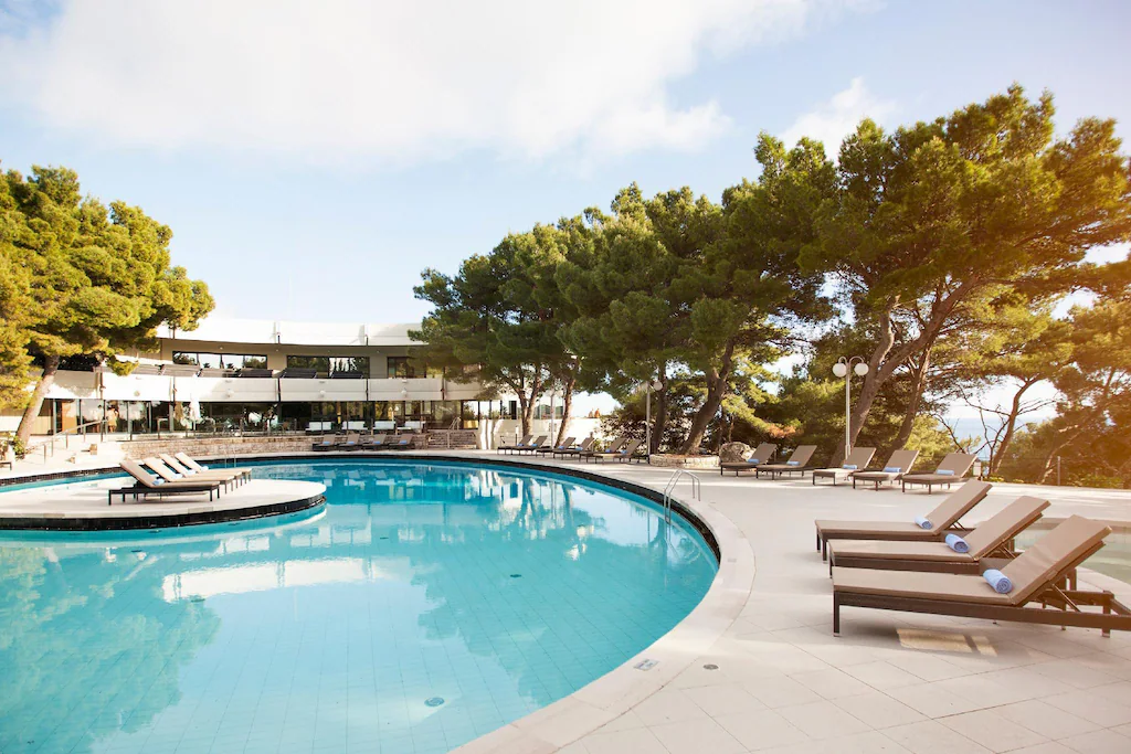 The outdoor pool at Hotel Cavtat provides GoGo Tours travelers a relaxing spot to unwind while enjoying the beautiful Adriatic surroundings during the Balkan Peninsula 14-Day Tour.
