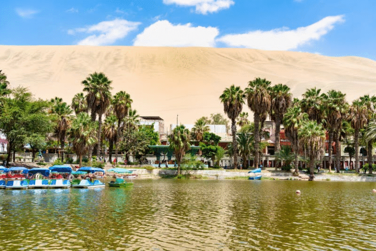 Oasis with palm trees and boats in Huacachina, Peru